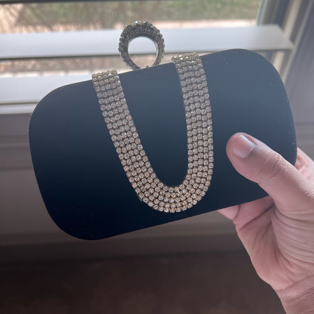 Crushed black velvet clutch bag. featured statement silver chain link strap.